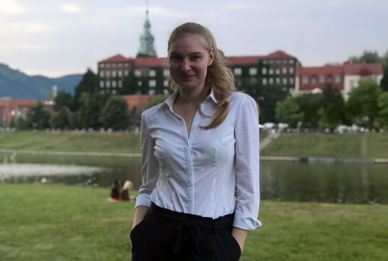 Woman in front of lake and castle